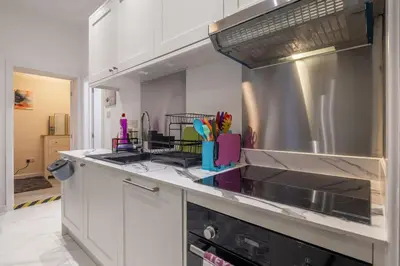 a kitchen with white cabinets and a sink at Newly refurbed 3Bed Annexe - With Parking! in Albury