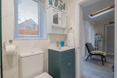 a bathroom with a sink and a toilet and a window at Newly refurbed 3Bed Annexe - With Parking! in Albury