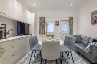 a kitchen and living room with a table and chairs at Newly refurbed 3Bed Annexe - With Parking! in Albury