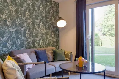 a living room with a couch and a table at Pass the Keys Ground Floor Apartment with Free Parking in Cambridge