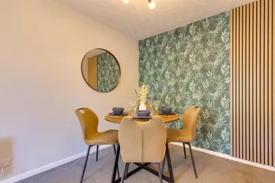 a dining room with a table with chairs and a mirror at Pass the Keys Ground Floor Apartment with Free Parking in Cambridge