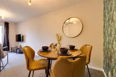 a dining room with a table with chairs and a mirror at Pass the Keys Ground Floor Apartment with Free Parking in Cambridge