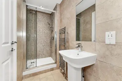 a bathroom with a sink and a shower at Chic 3Bed House & Garden Near Shelford High Street in Trumpington