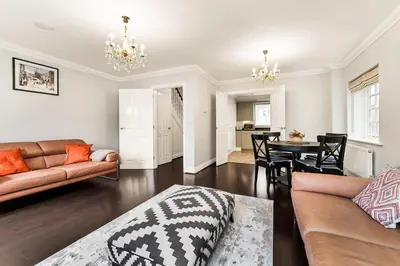 a living room with a couch and a table at Chic 3Bed House & Garden Near Shelford High Street in Trumpington