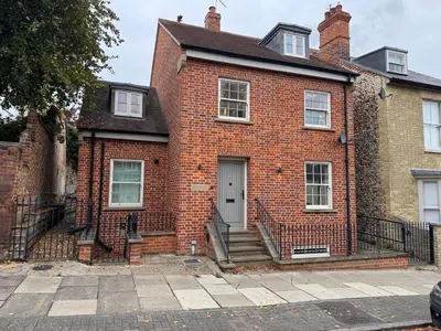 a red brick house with stairs in front of it at 4 bed Townhouse in Central Bury St Edmunds in Bury Saint Edmunds