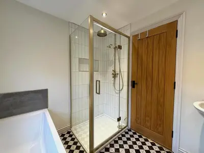 a shower with a glass door in a bathroom at 4 bed Townhouse in Central Bury St Edmunds in Bury Saint Edmunds