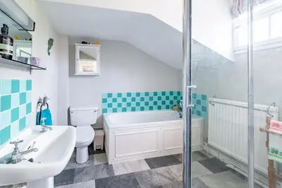 a bathroom with a tub and a sink and a toilet at Sanderlings 4 in Aldeburgh