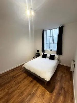a bedroom with a white bed and a window at Cosy Apartment in Chelmsford City, Free WiFi & Free Parking - Durrant Apartment by Stays Accommodation - Long Stays Welcome in Chelmsford