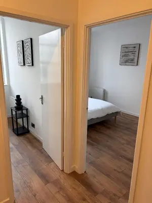 a bedroom with a door leading to a bed at Cosy Apartment in Chelmsford City, Free WiFi & Free Parking - Durrant Apartment by Stays Accommodation - Long Stays Welcome in Chelmsford