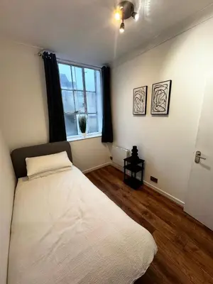 a bedroom with a white bed and a window at Cosy Apartment in Chelmsford City, Free WiFi & Free Parking - Durrant Apartment by Stays Accommodation - Long Stays Welcome in Chelmsford