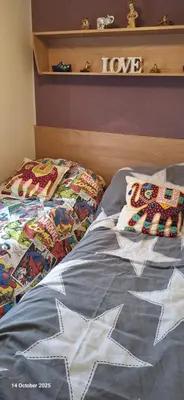 a bed with two pillows on top of it at Heavenly Huts GC056 in Saint Osyth