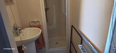 a small bathroom with a sink and a shower at Heavenly Huts GC056 in Saint Osyth