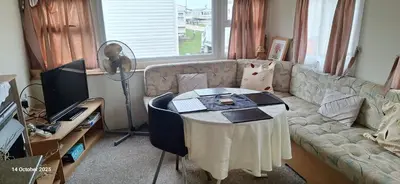 a living room with a couch and a table at Heavenly Huts GC056 in Saint Osyth
