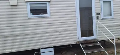 a house with a window and a ladder next to it at Heavenly Huts GC056 in Saint Osyth