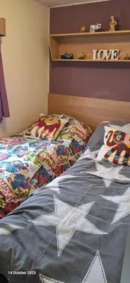 a bed with a comforter that says i love at Heavenly Huts GC056 in Saint Osyth