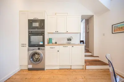 a kitchen with a washer and dryer in a room at Suffolk House, Saxmundham in Saxmundham