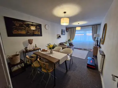a living room with a dining room table and a couch at The Green Box in Great Clacton