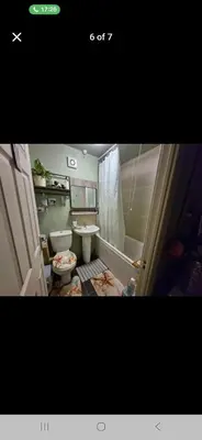 a bathroom with a shower and a toilet and a sink at The Green Box in Great Clacton