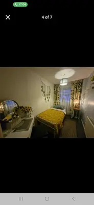 a small room with a bed and a sink at The Green Box in Great Clacton