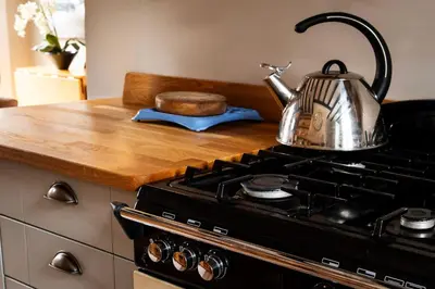 a tea kettle sitting on top of a stove at Old Customs House in Harwich