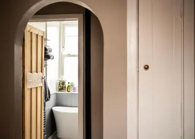 a bathroom with a white tub and a sink at Old Customs House in Harwich