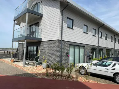 a house with a car parked in front of it at Ten Admiralty Pier in Shotley Gate