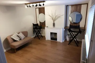 a living room with a couch and a mirror at The Granary Cottages
