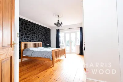 a bedroom with a bed and a wall at Harvest Close, Marks Tey in Marks Tey