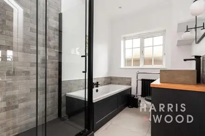 a bathroom with a bath tub and a sink at Harvest Close, Marks Tey in Marks Tey