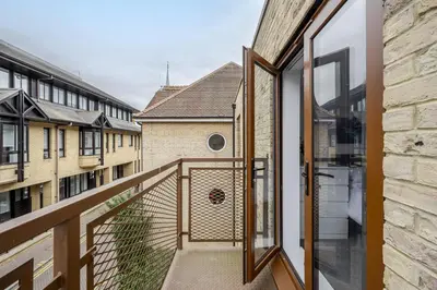 a view from the balcony of a house with glass doors at Modern Apartment in Chelmsford City, Free WiFi & Free Parking - Dukes Apartment by Stays Accommodation - Long Stays Welcome in Chelmsford