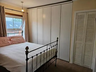 a bedroom with a bed and a window at B&B Rooms in terraced house in Sudbury centre in Sudbury