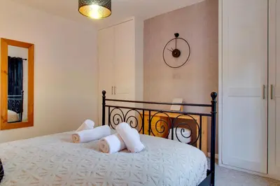 a bedroom with a bed with white pillows on it at Stylish Victorian Terrace in Central Cambridge Pass the Keys in Cambridge