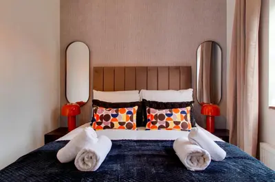a bedroom with a bed with towels on it at Stylish Victorian Terrace in Central Cambridge Pass the Keys in Cambridge