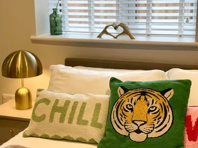a pillow with a tiger on it sitting on a bed at Luxury 1 bed new build house near Science & Business parks in Cambridge