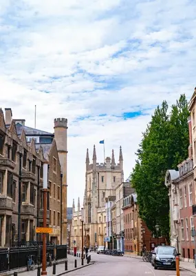 a city street with buildings and a car on the road at Luxury 1 bed new build house near Science & Business parks in Cambridge