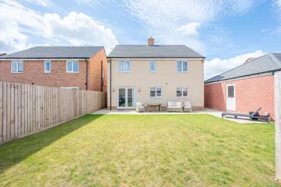 an image of a house with a yard at A Superb 5BR House near SZC in Leiston