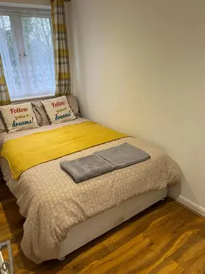 a small bed in a bedroom with a window at Maxismile Haven in Southend-on-Sea