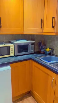 a kitchen with a microwave and a sink at Maxismile Haven in Southend-on-Sea