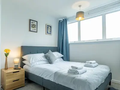 a bedroom with a bed with towels on it at Pass the Keys Large 4 Bedroom Home Stunning views Contractor in Basildon