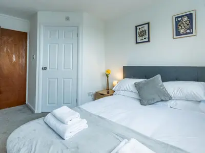 a bedroom with two beds with towels on top at Pass the Keys Large 4 Bedroom Home Stunning views Contractor in Basildon