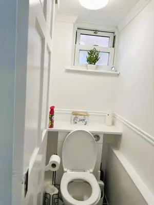 a small bathroom with a toilet and a window at Ama comfort Stay in Hythe