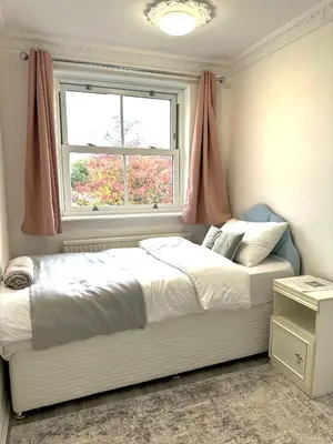 a bedroom with a large bed and a window at Ama comfort Stay in Hythe