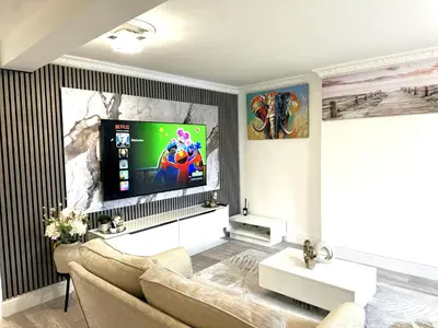 a living room with a tv and a couch at Ama comfort Stay in Hythe