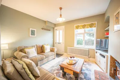 a living room with a couch and a table at Number 22, Leiston Road, Aldeburgh in Aldeburgh