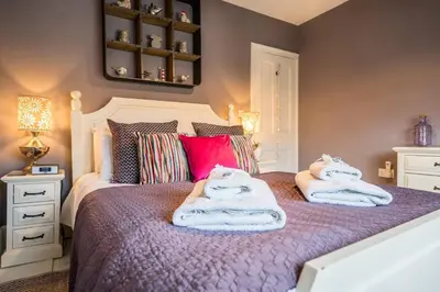 a bedroom with a bed with towels on it at Number 22, Leiston Road, Aldeburgh in Aldeburgh