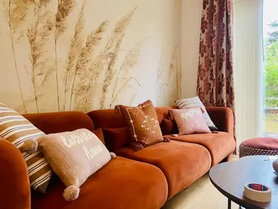 a living room with a couch and a table at Autumn House Cambridge free parking in Trumpington