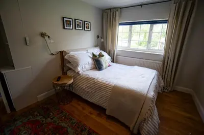 a small bedroom with a bed and a window at Beautiful 2 Bed Home with Spacious Garden in Shephall