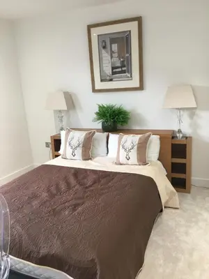 a bedroom with a large bed with pillows at Spacious 3-bedroom Ipswich House with Parking in Ipswich
