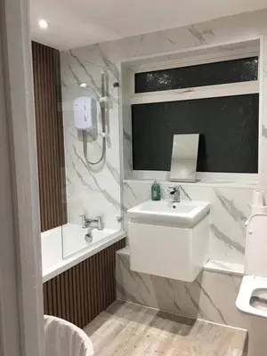a white bathroom with a sink and a mirror at Spacious 3-bedroom Ipswich House with Parking in Ipswich