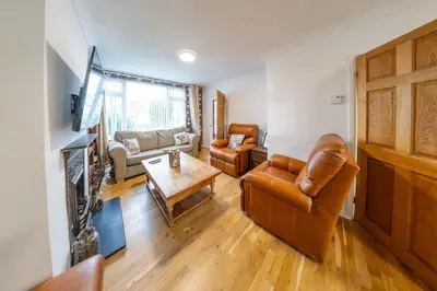 a living room with a couch and a table at Pass the Keys 3-Bedroom Home in Chelmsford Sleeps 7 in Chelmsford